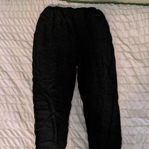 A pair of black flowy high waisted ankle length pants